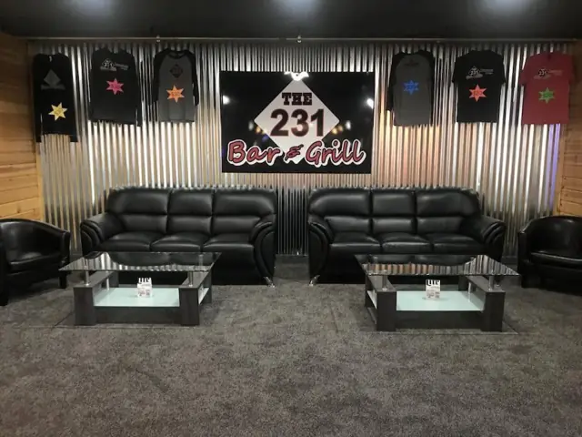 Black leather lounge seating under The 231 banner